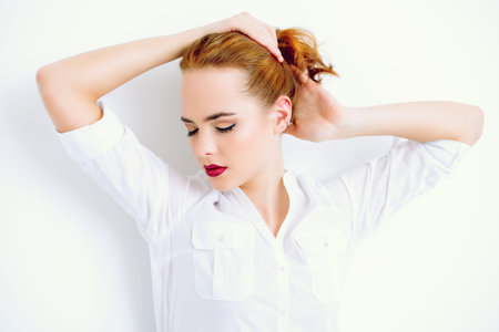 Make-up, cosmetics concept. Exciting young woman with beautiful foxy hair and sensual red lips....