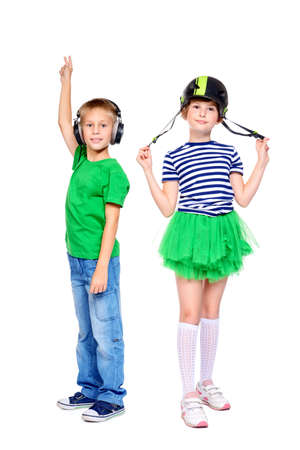 Portrait of two modern children in bright clothes. Isolated over white background. Copy space.の写真素材