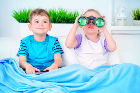 Two funny children playing together at home.の写真素材