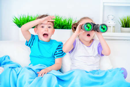 Two funny children playing together at home.の写真素材