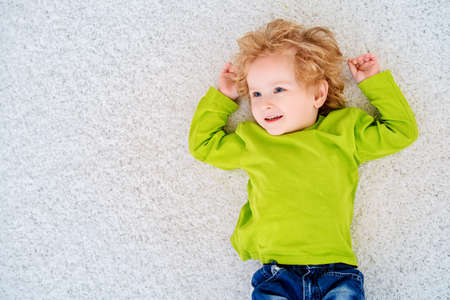 Happy 3 year old boy is playing at home. Child concept.の写真素材