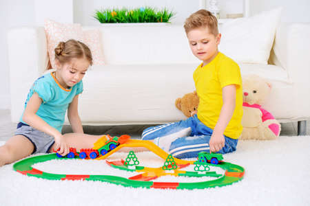 Happy joyful children playing together at home. Family concept.の写真素材