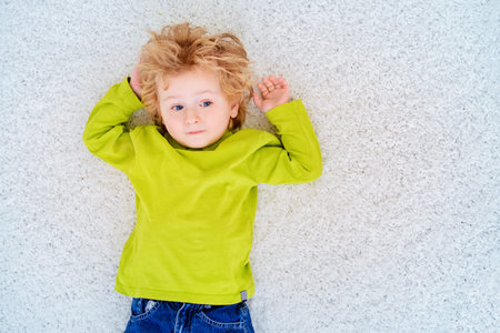 Happy 3 year old boy is playing at home. Child concept.の写真素材