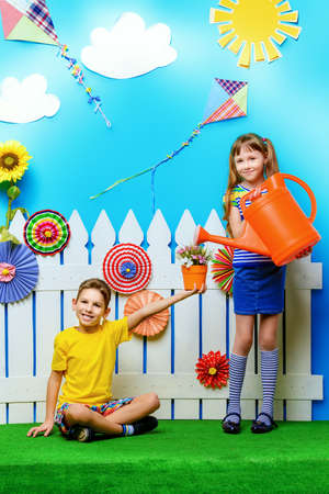 Happy joyful children in a summer garden. Children's fashion. Happiness, activity and child concept.の写真素材