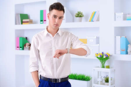 Confident young businessman in white shirt at the office. Business lifestyle.の写真素材