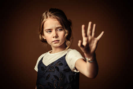 Portrait of a beautiful eight year old girl with serious calm look. Childhood concept.の写真素材