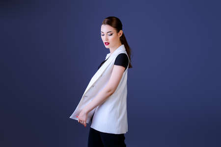 Fashion shot. Professional vogue model posing at studio. Collection of business clothes.の写真素材