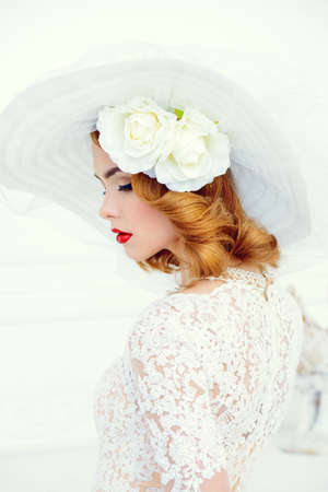 Portrait of a beautiful tender bride woman wearing elegant lace dress and broad-brimmed hat. Wedding. Beauty, fashion concept.の写真素材