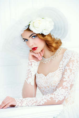Portrait of a beautiful tender bride woman wearing elegant lace dress and broad-brimmed hat. Wedding. Beauty, fashion concept.の写真素材