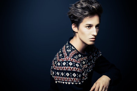 Man's hairstyle. Portrait of a handsome young man with stylish hair. Beauty, fashion.