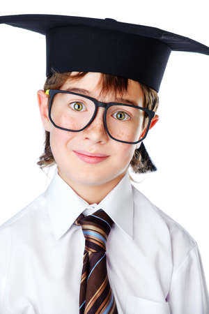 Portrait of a smart student boy in white shirt, a tie and academic hat. Educational concept. Isolated over white.の写真素材