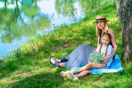 Happy family having fun in the park on a sunny summer day.の写真素材