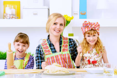 Loving family concept. Happy mother cooks with her daughters.の写真素材