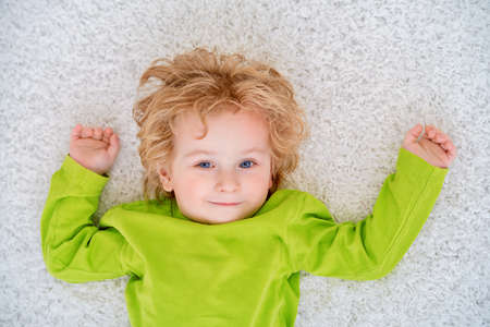 Close-up portrait of a cute 3 year old boy at home. Healthcare. Happy childhood.の写真素材