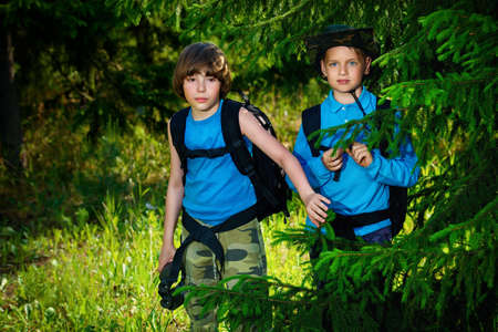 Two boys friends go hiking with backpacks. Summer holidays. Outdoor activities.の写真素材