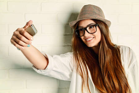 Pretty young woman making selfie on her cell phone.の写真素材