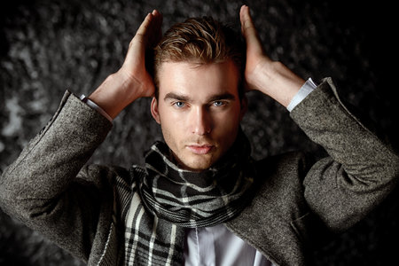 Male beauty, fashion. Portrait of a handsome man. Male hairstyle, haircare.の写真素材