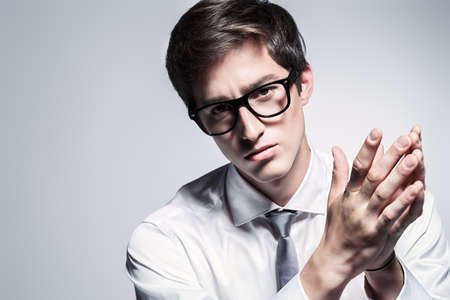 Portrait of a handsome young man posing in white shirt and a tie. Business style. Studio fashion shot.の写真素材
