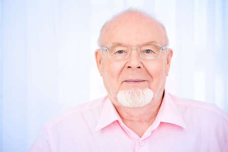 Happy smiling old man having a rest at home. Retirement.の写真素材