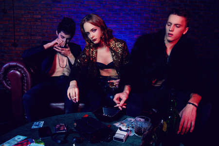 Modern young people spending time at night club or casino. Entertainment industry. Beauty, fashion concept.の写真素材