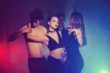 Disco, night party concept. Group of cheerful young people dancing at a night party. Beauty, fashion. Entertainment.の写真素材