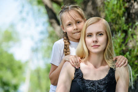 Family concept. Happy mother spending time with her little daughter in the park. Summer holidays.の写真素材