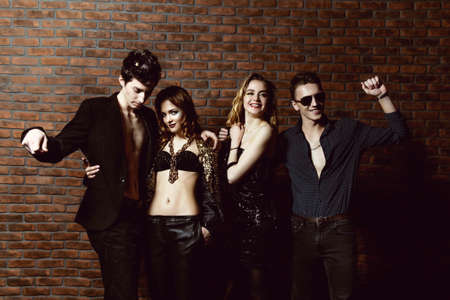 Disco, night party concept. Group of cheerful young people dancing at a night party. Beauty, fashion. Entertainment.の写真素材