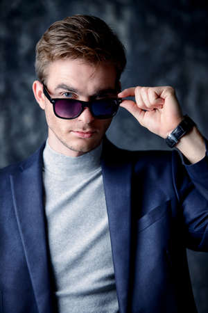 Business concept. Portrait of a handsome businessman wearing suit and sunglasses.の写真素材