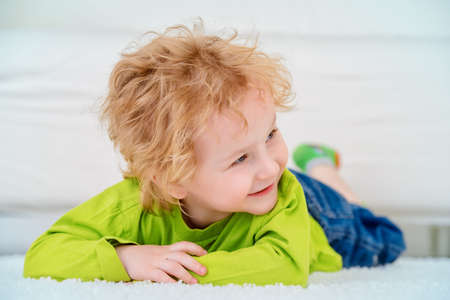 Happy 3 year old boy is playing at home. Child concept.の写真素材