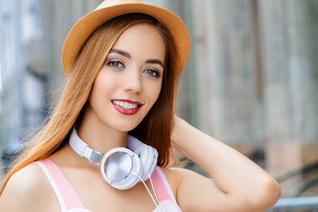 Happy smiling young woman on a sunny summer day. City street. Beauty, fashion.の写真素材
