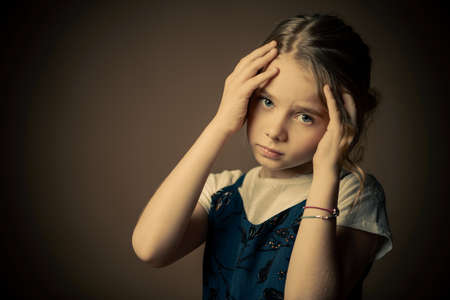 Portrait of a beautiful eight year old girl with calm pensive look.の写真素材