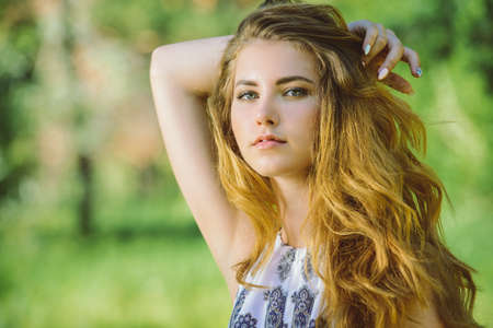 Attractive young woman with magnificent long hair posing outdoor. Beauty, fashion concept.の写真素材