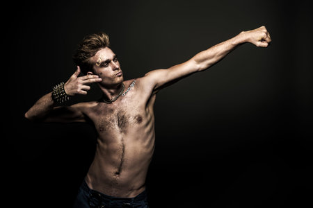 Bad boy concept. A portrait of a bad guy demonstrating antisocial behavior, rudeness and aggression. Rocker, punk.の写真素材