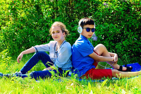 Two children friends spending time together in the park on a sunny day. Summer holidays. Friendship.の写真素材