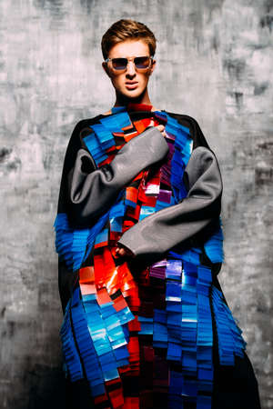 Men's beauty, fashion. Portrait of a handsome male model posing in stylish designer clothing. Studio shot.の写真素材