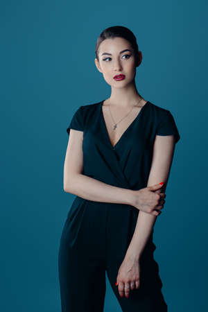 Beauty and makeup concept. Portrait of a beautiful brunette woman with perfect skin and bright makeup. Eyeliner, arrows.の写真素材