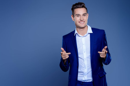 Portrait of a handsome young man in elegant classic suit. Men's beauty, fashion. Businessman. Copy space.の写真素材