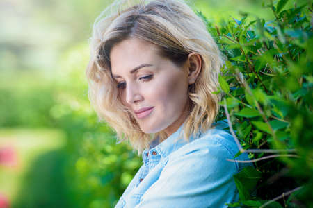 Happy middle aged woman on a summer day. Mood of summer and carefree vacations. Beauty, cosmetics.の写真素材