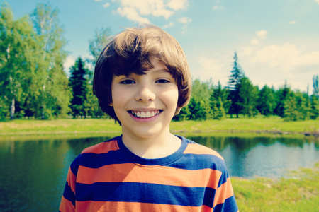 Cheerful boy on a sunny summer day.の写真素材
