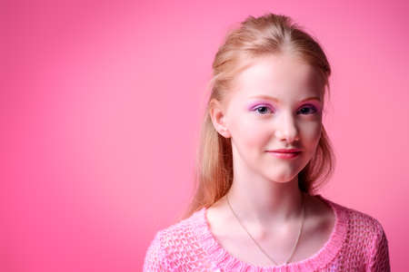 Cute girl teenager over pink background.の写真素材