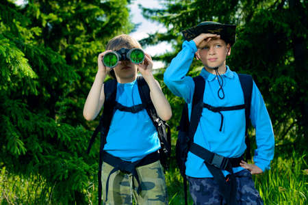 Two boys friends go hiking with backpacks.の写真素材