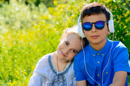 Two children friends spending time together in the park on a sunny day.の写真素材