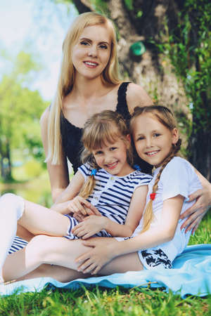 Happy family having fun in the park on a sunny summer day.の写真素材