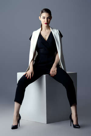 Fashion shot. Professional vogue model posing at studio. Collection of business clothes. Full length portrait.の写真素材