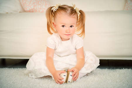 Cute two year old girl playing at home. Happy childhood.の写真素材