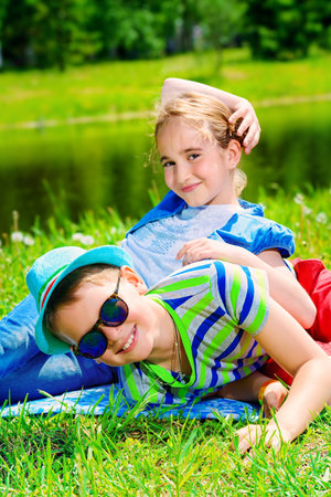 Two children friends spending time together in the park on a sunny day. Summer holidays. Friendship.の写真素材