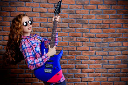 Portrait of an attractive girl with electric guitar.の写真素材