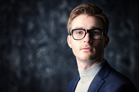 Business concept. Portrait of a handsome businessman wearing suit and glasses.