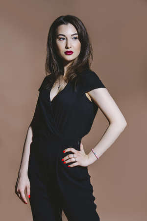 Beauty and makeup concept. Portrait of a beautiful brunette woman with perfect skin and bright makeup. Eyeliner, arrows.の写真素材