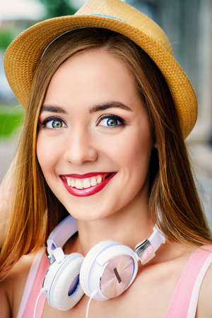 Happy smiling young woman on a sunny summer day. City street. Beauty, fashion.の写真素材